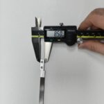 Measuring a part with a caliper