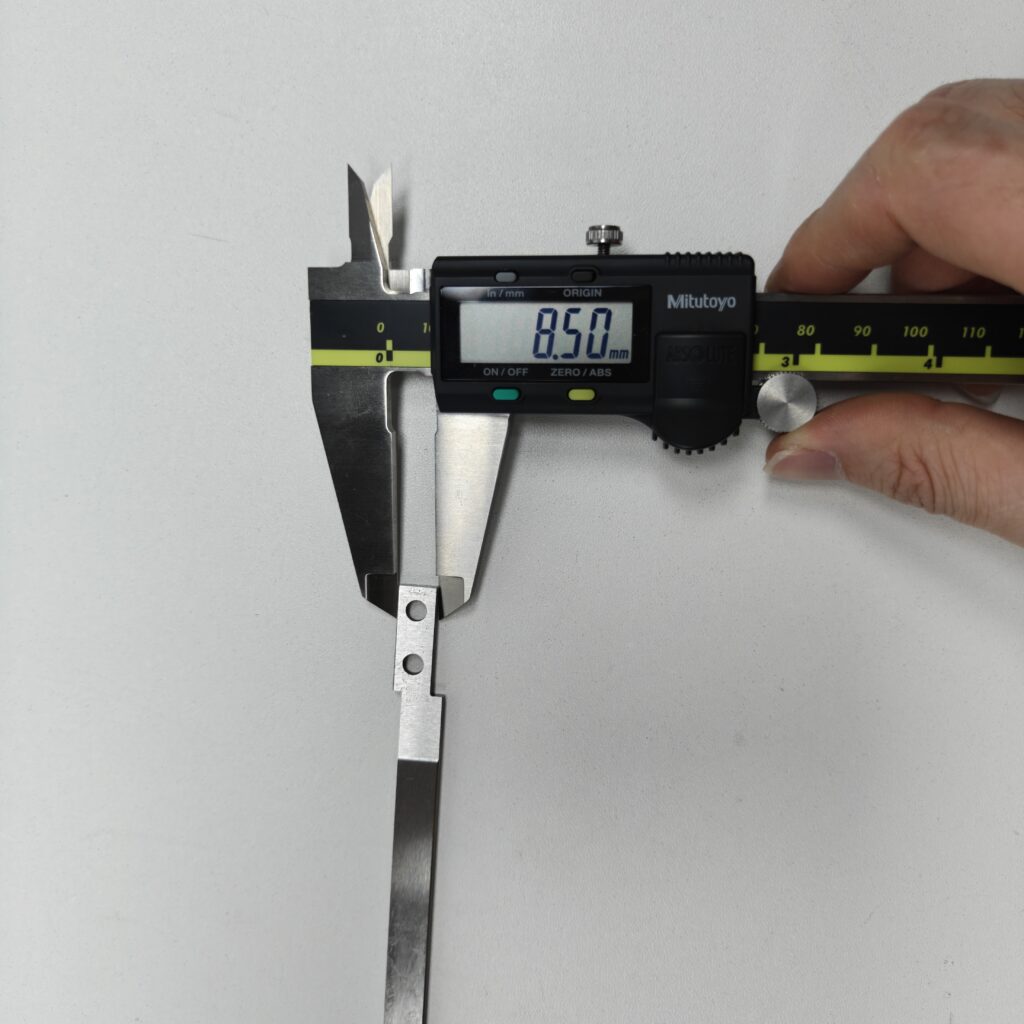 Measuring a part with a caliper